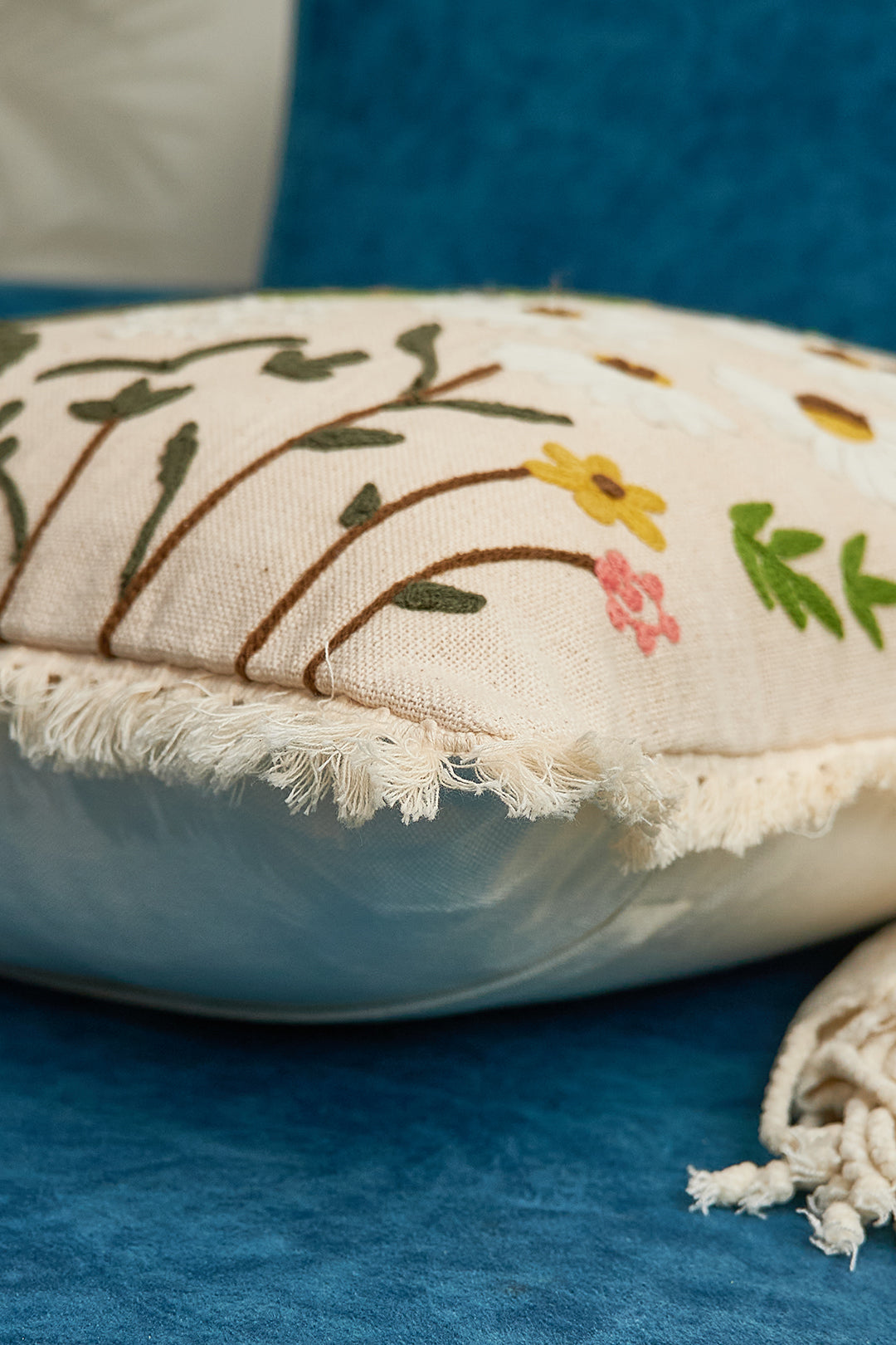 a white pillow with a floral design on it