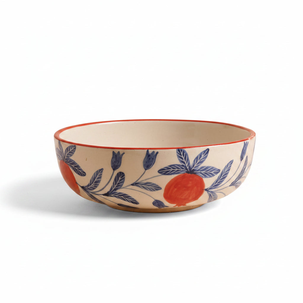 A large ceramic serving bowl with a red rim and blue floral patterns on a beige background.