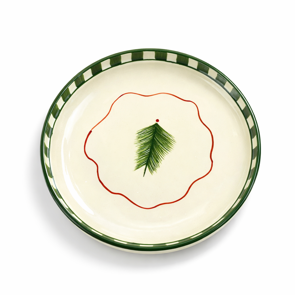 Decorative plate with green rim and leaf design on a white background