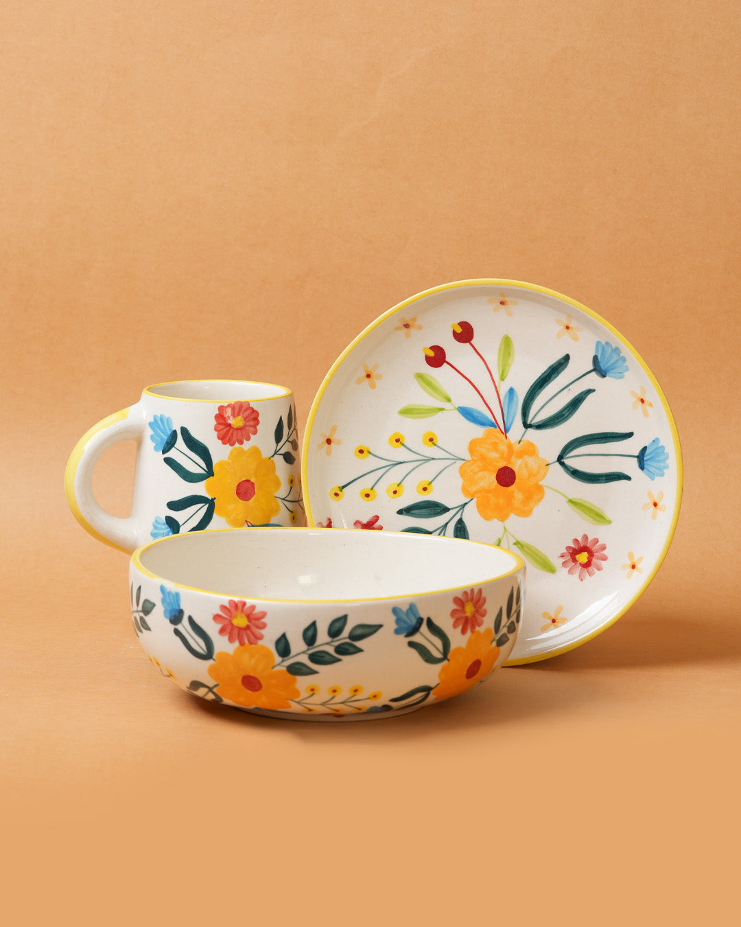 Ceramic tableware set with floral design on a brown background