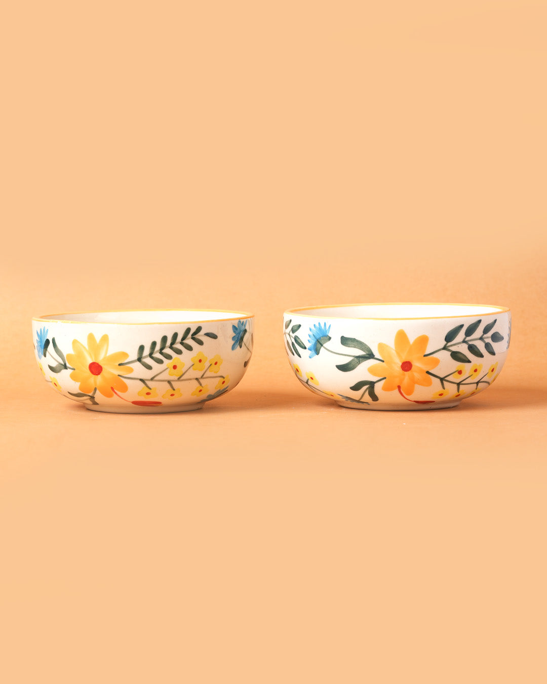 Two ceramic bowls with floral designs on a beige background
