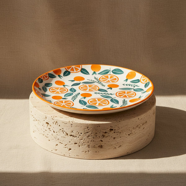 Decorative plate with orange and leaf pattern on a white background