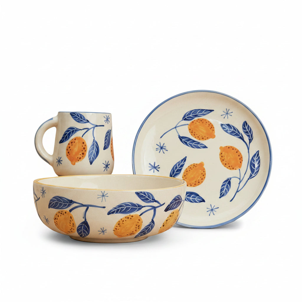 A set of breakfastware with a floral pattern, predominantly featuring yellow and green colors, on a beige background.