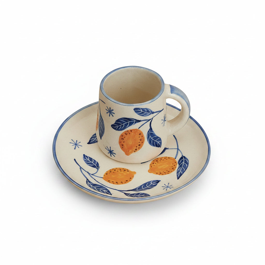 A set of breakfastware with a floral pattern, predominantly featuring yellow and green colors, on a beige background.