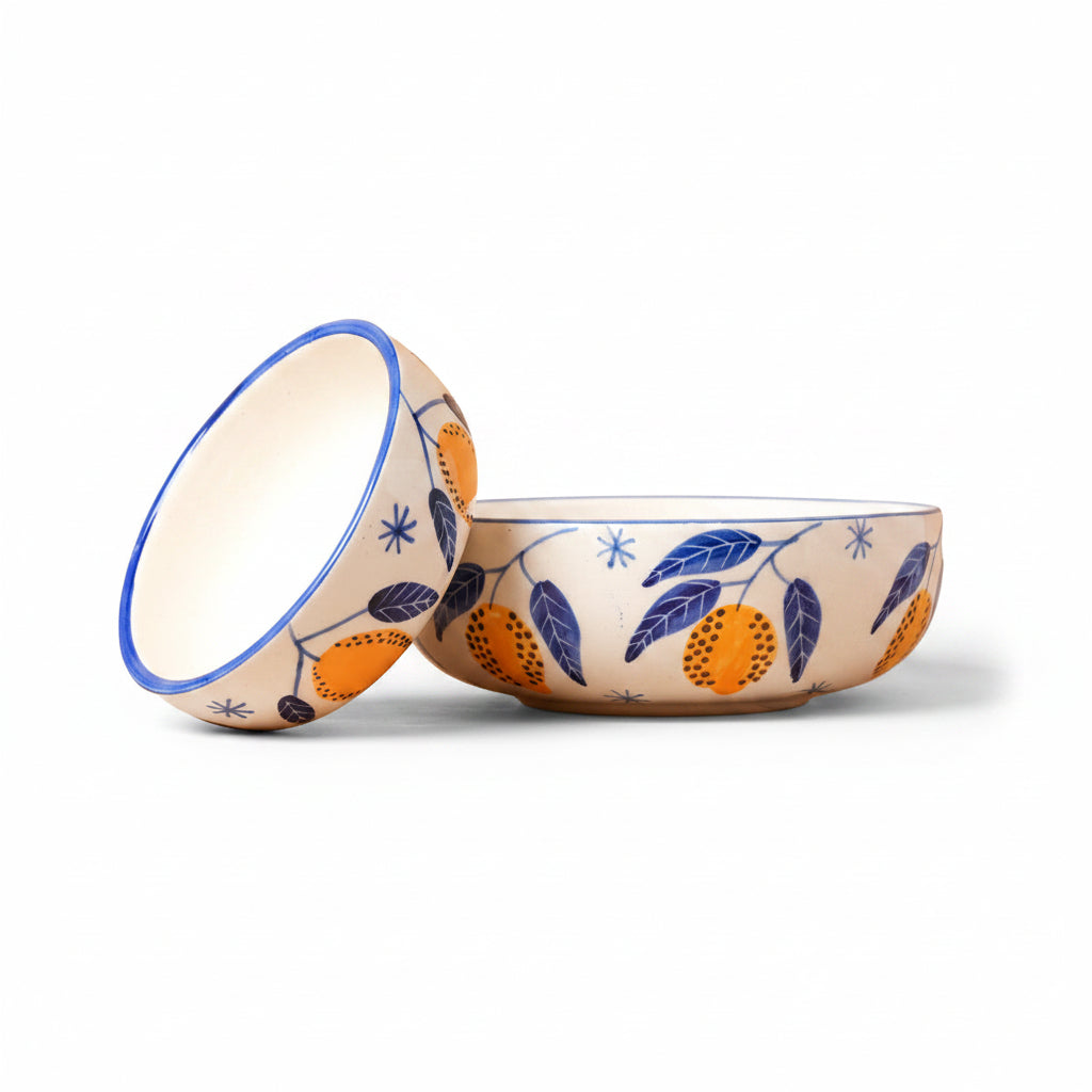 Decorative ceramic bowl with floral and fruit design on a beige background