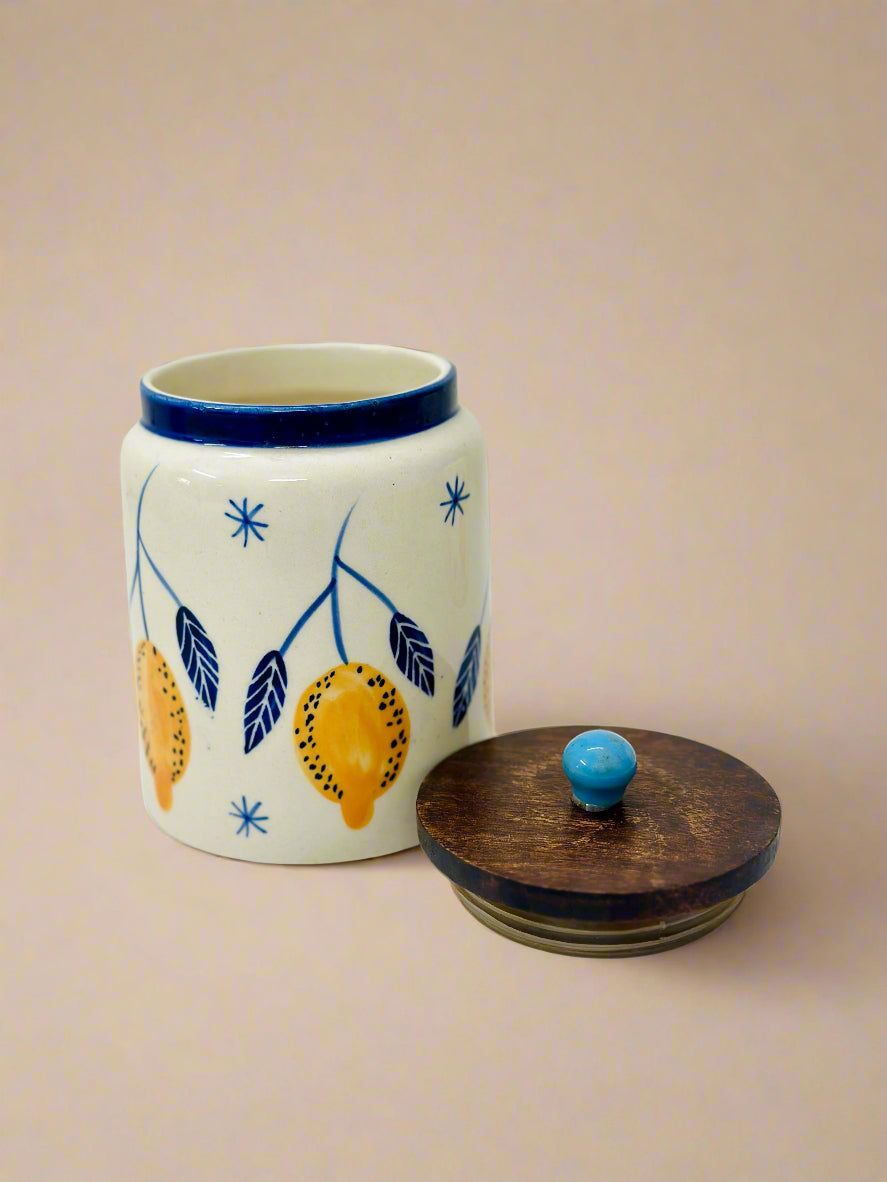 Ceramic jar with decorative elements and wooden lid on a white background