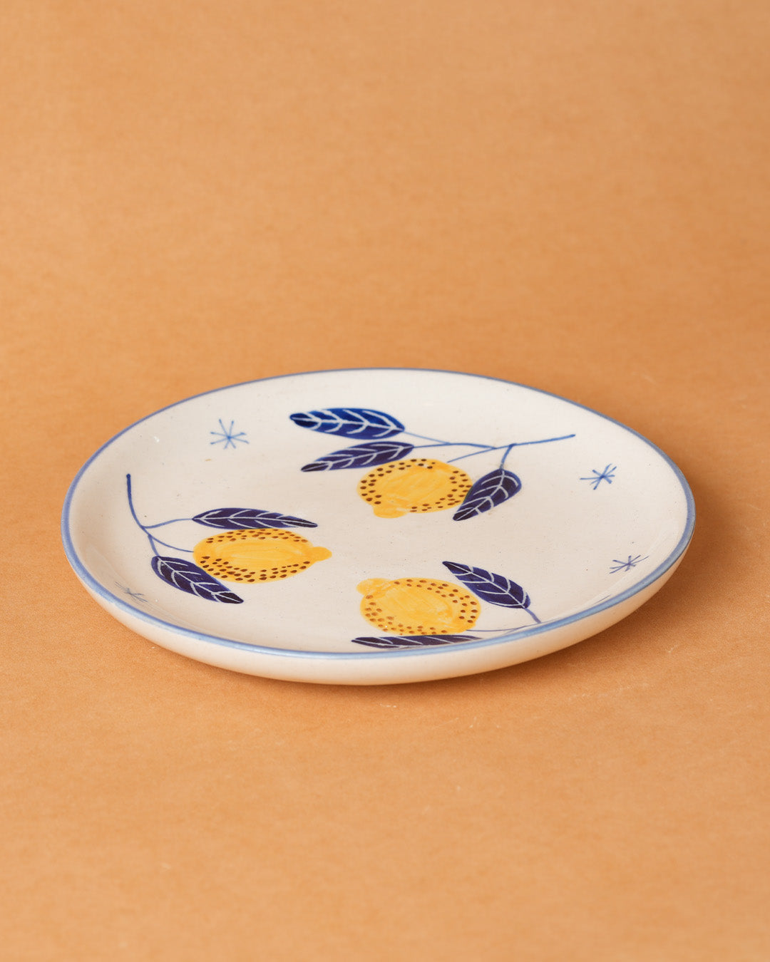 Ceramic plate with lemon design on a beige background