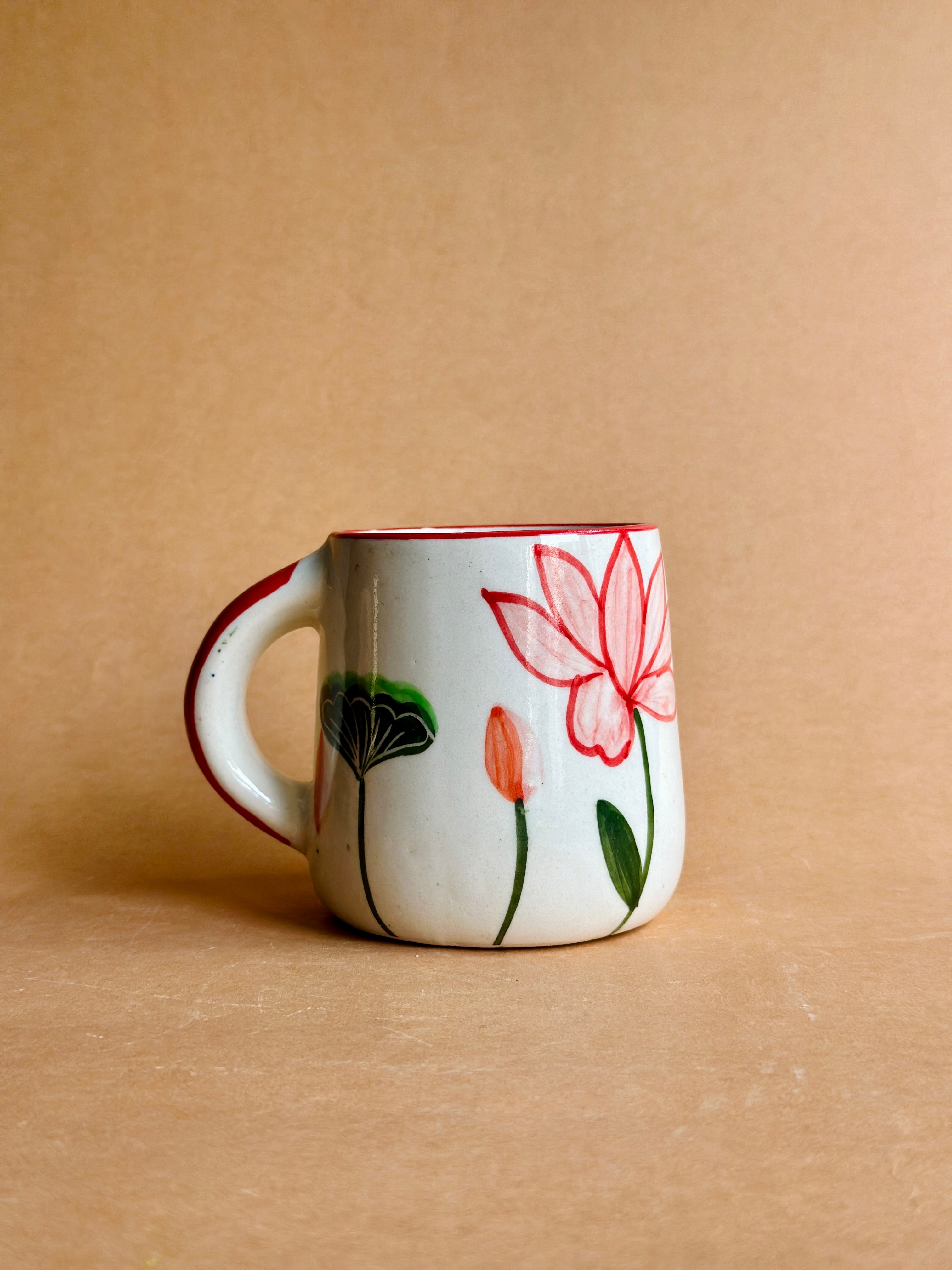 Ceramic mug with floral design on a beige background