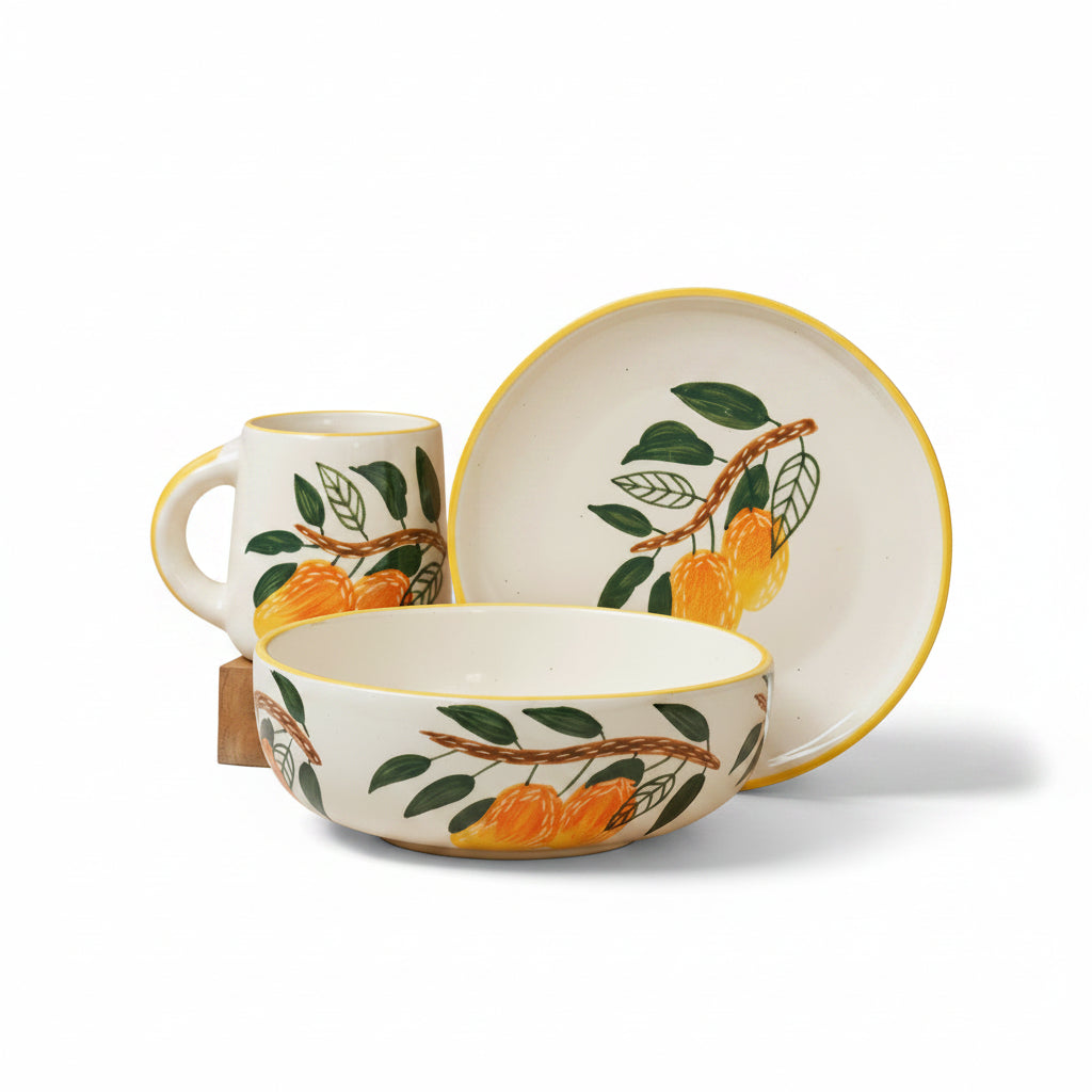 Ceramic set with mug, bowl, and plate featuring orange and leaf design on a beige background