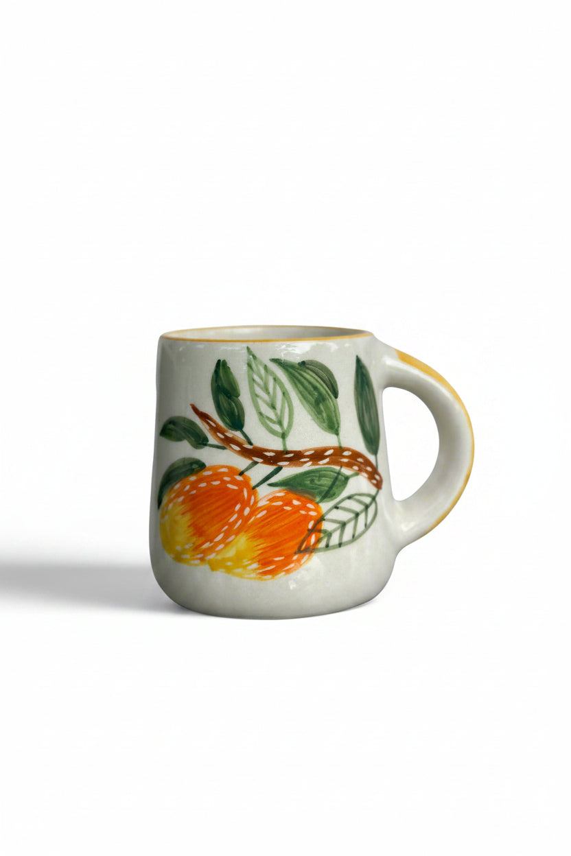 Mug with fruit design on a reflective surface
