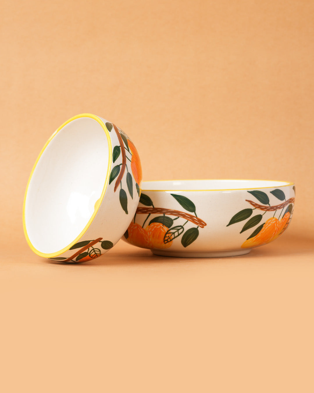 Two ceramic bowls with floral patterns on a beige background