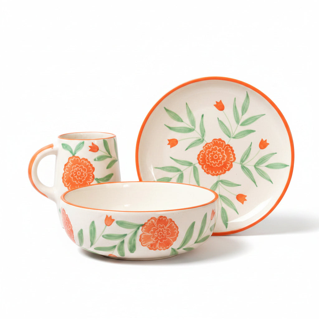 Ceramic bowl, mug, and plate set with floral design on a beige background