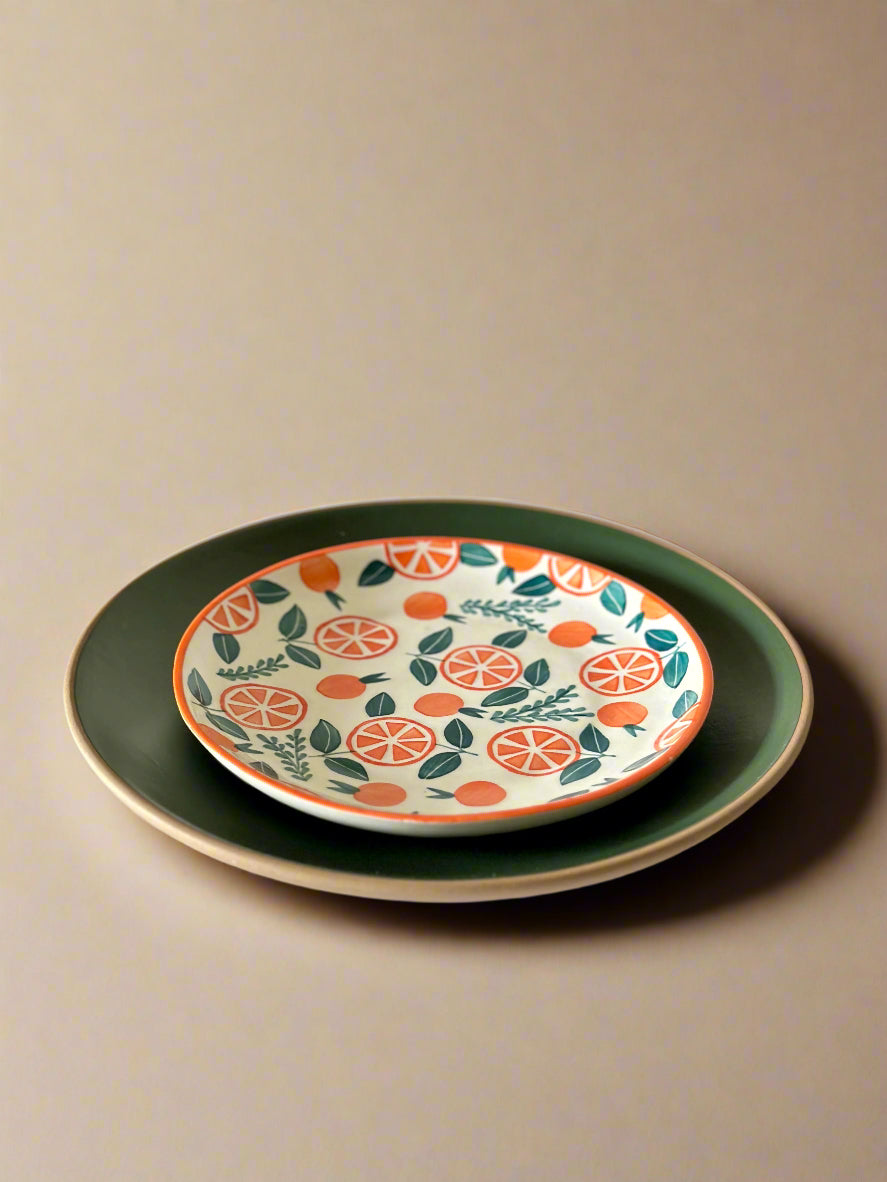Decorative ceramic plate with fruit pattern on a plain background
