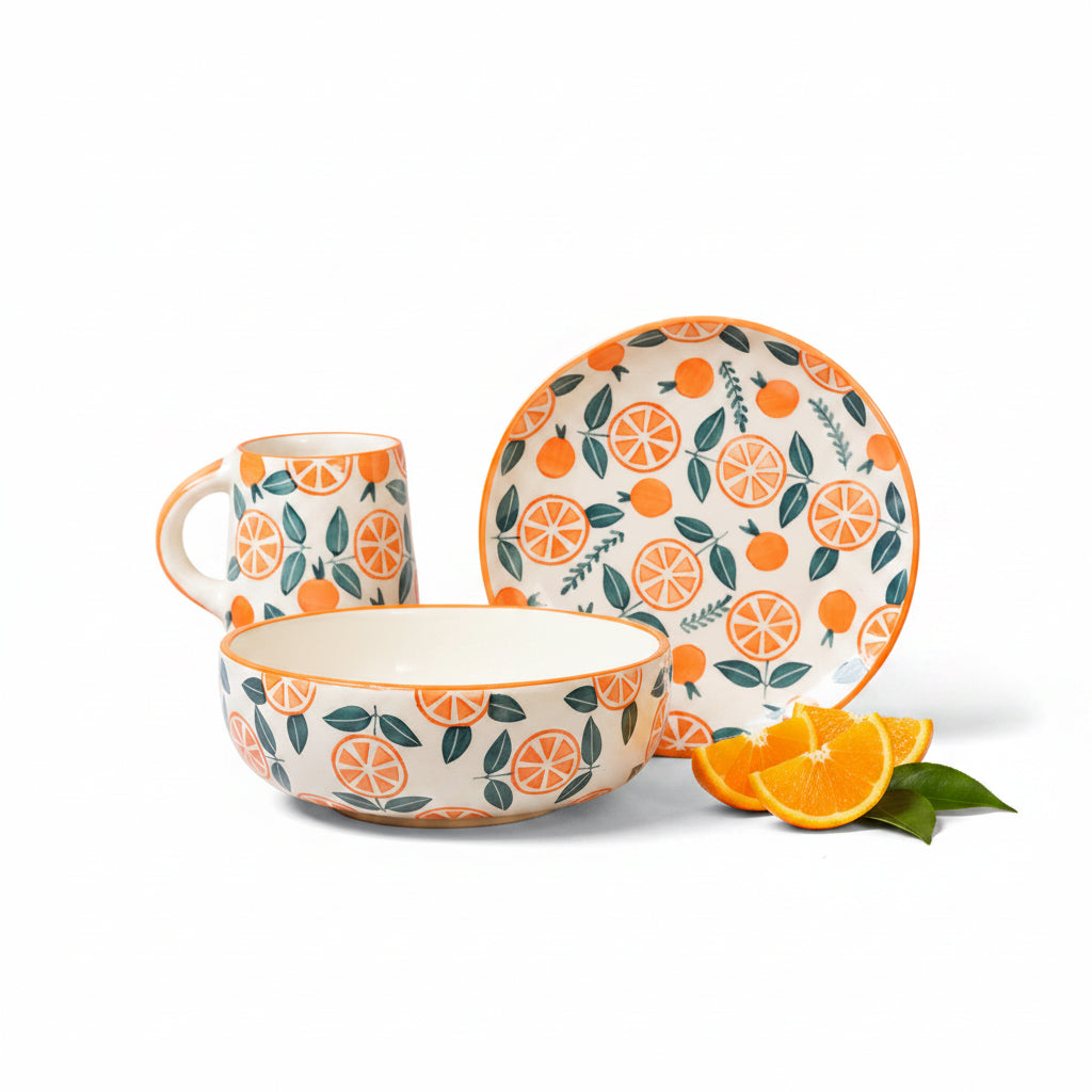 Ceramic tableware set with orange and leaf pattern on a beige background