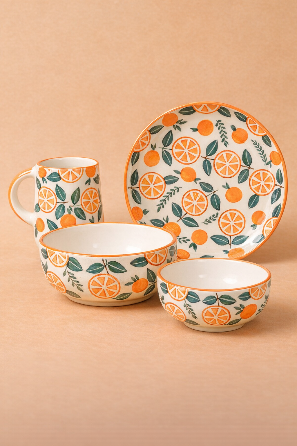 Ceramic tableware set with orange and leaf pattern on a beige background