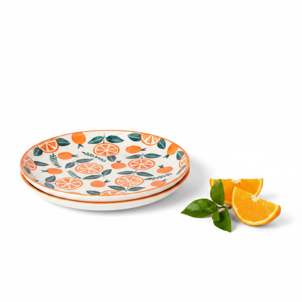 Two ceramic plates with orange and leaf pattern on an orange background