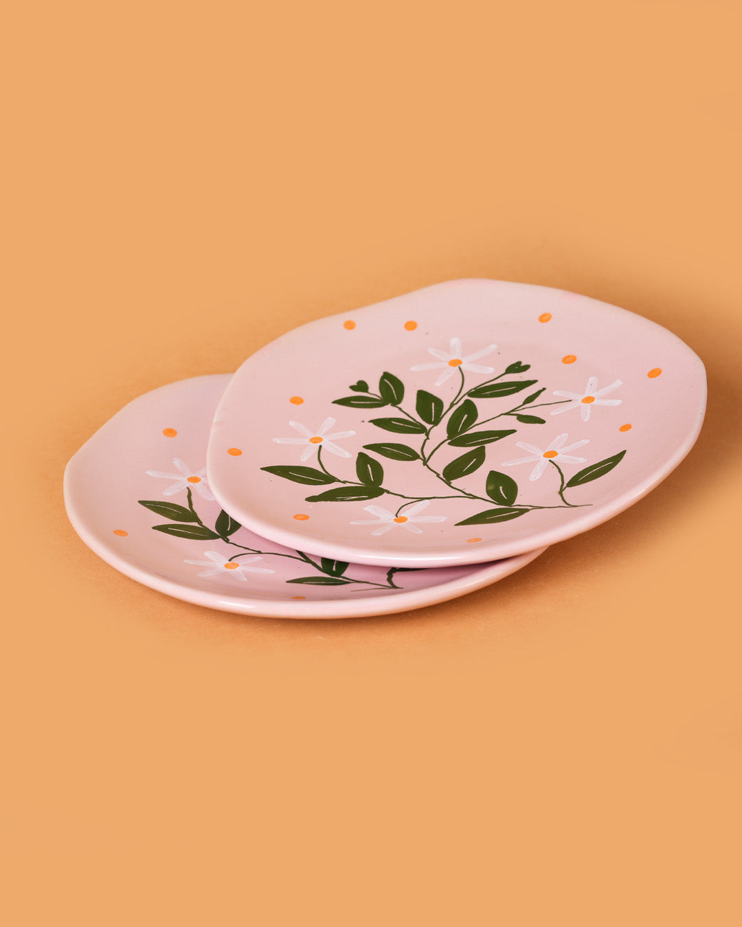 Set of ceramic plates with floral design on a beige background