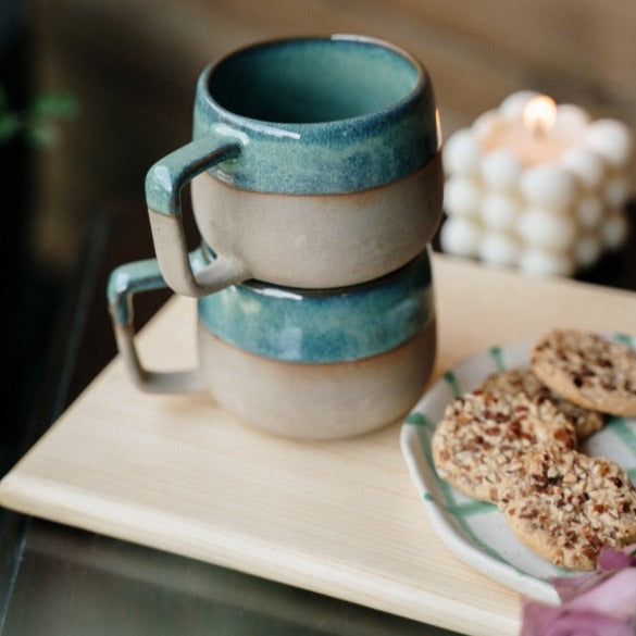 a cup of coffee and some cookies on a tray