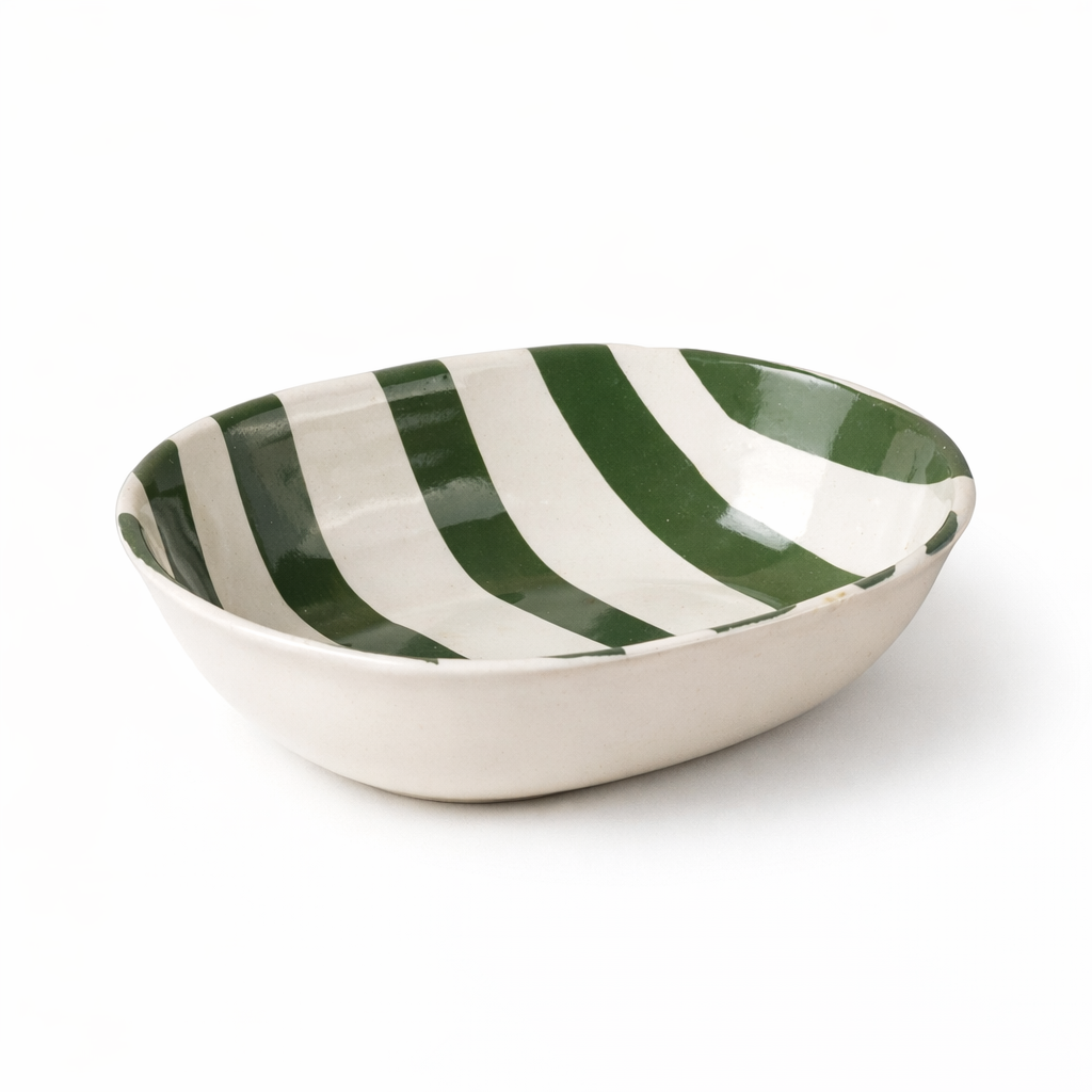 Green and white striped ceramic bowl on a white background