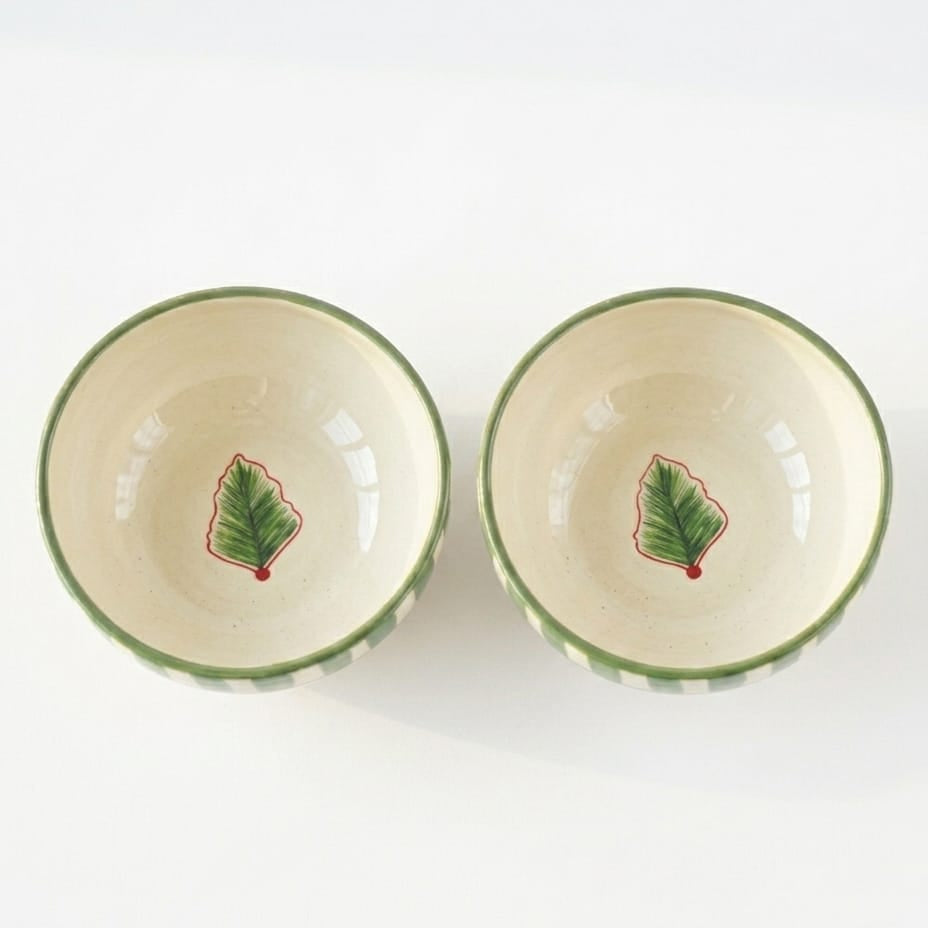 Two ceramic bowls with leaf design on a white background