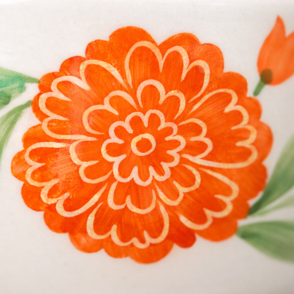 Close-up of an orange floral design on a white background