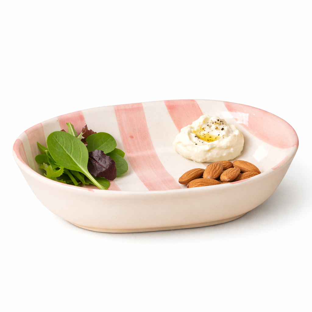 Small bowl with salad, hummus, and almonds on a white background