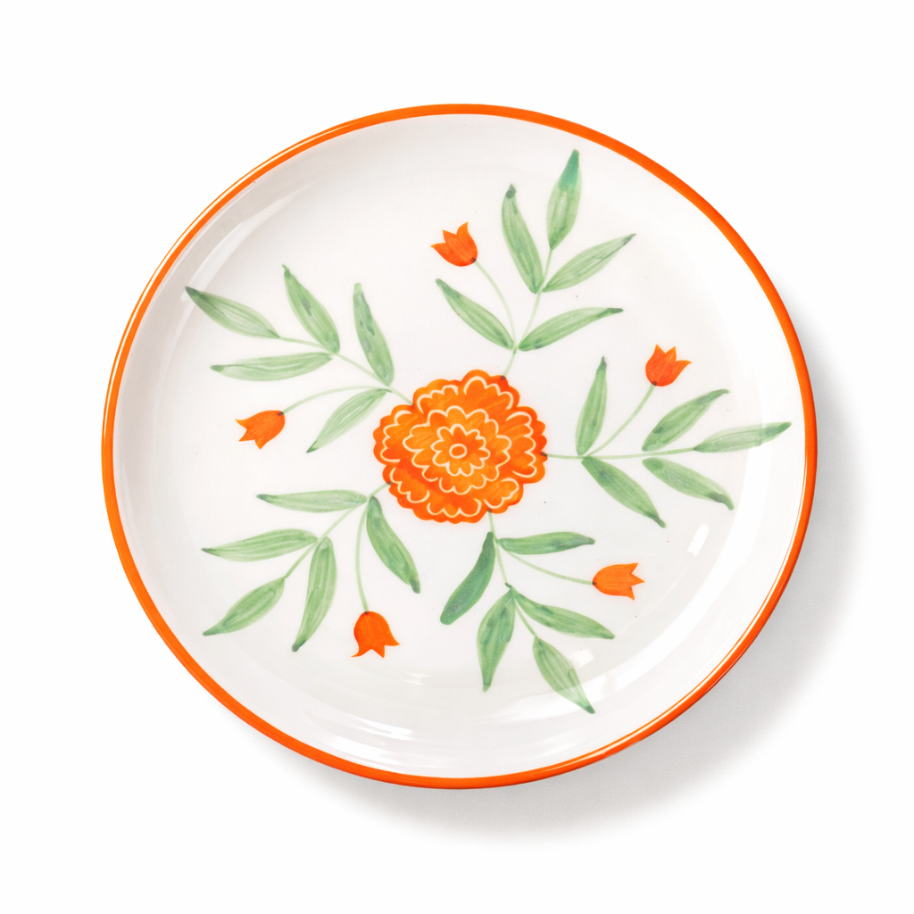 Decorative plate with orange floral design on a white background