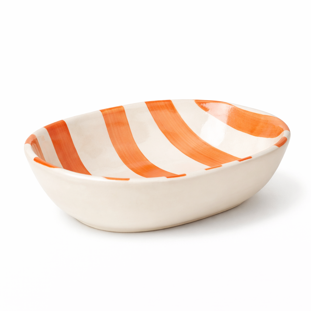 Ceramic bowl with orange and white stripes on a white background