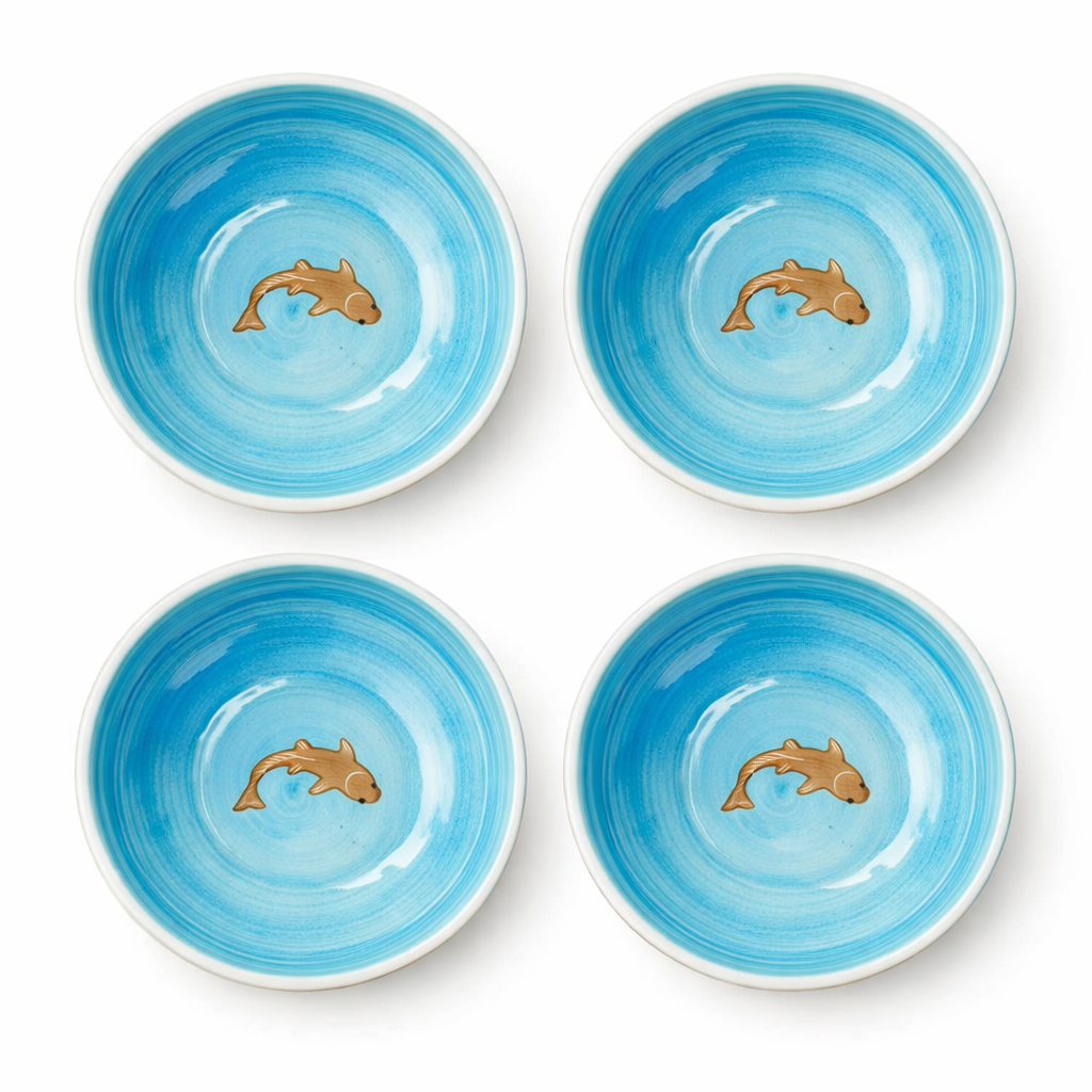 Four blue ceramic bowls with dolphin designs on a white background