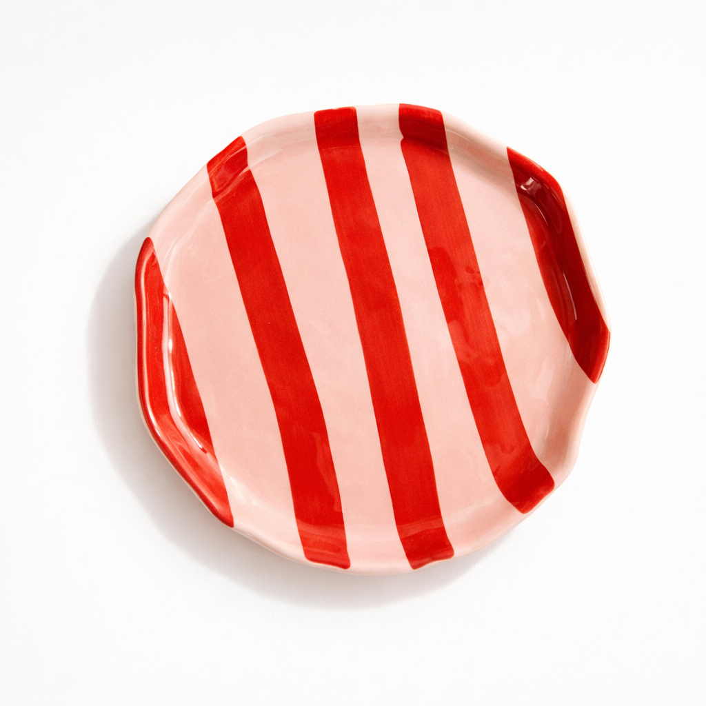 Red and white striped ceramic plate on a white background