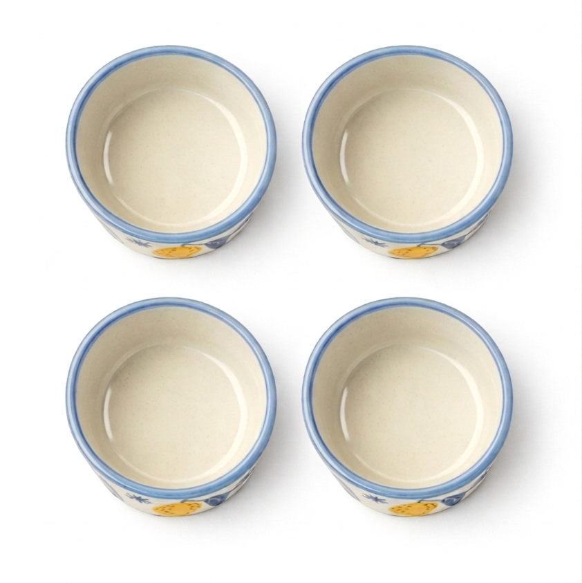 Four ceramic bowls with blue rims on a white background