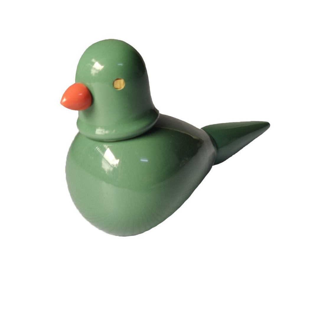 a green ceramic bird with an orange beak