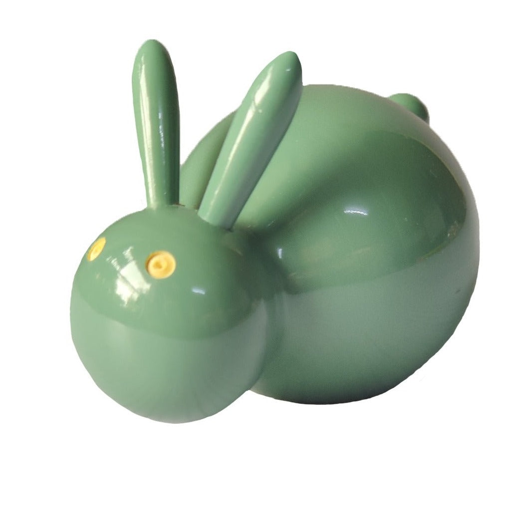 a green ceramic rabbit shaped object on a white background