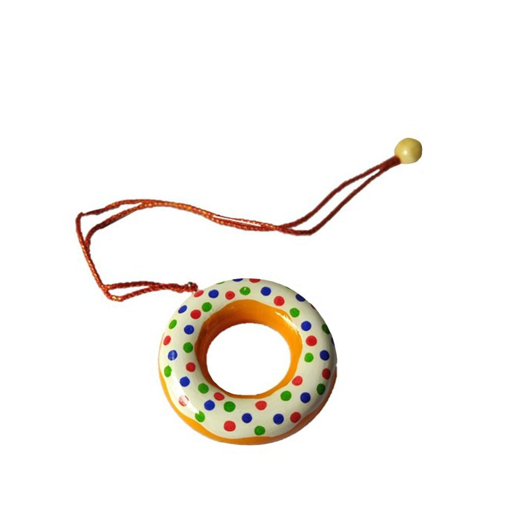 a toy donut with a string on a white background