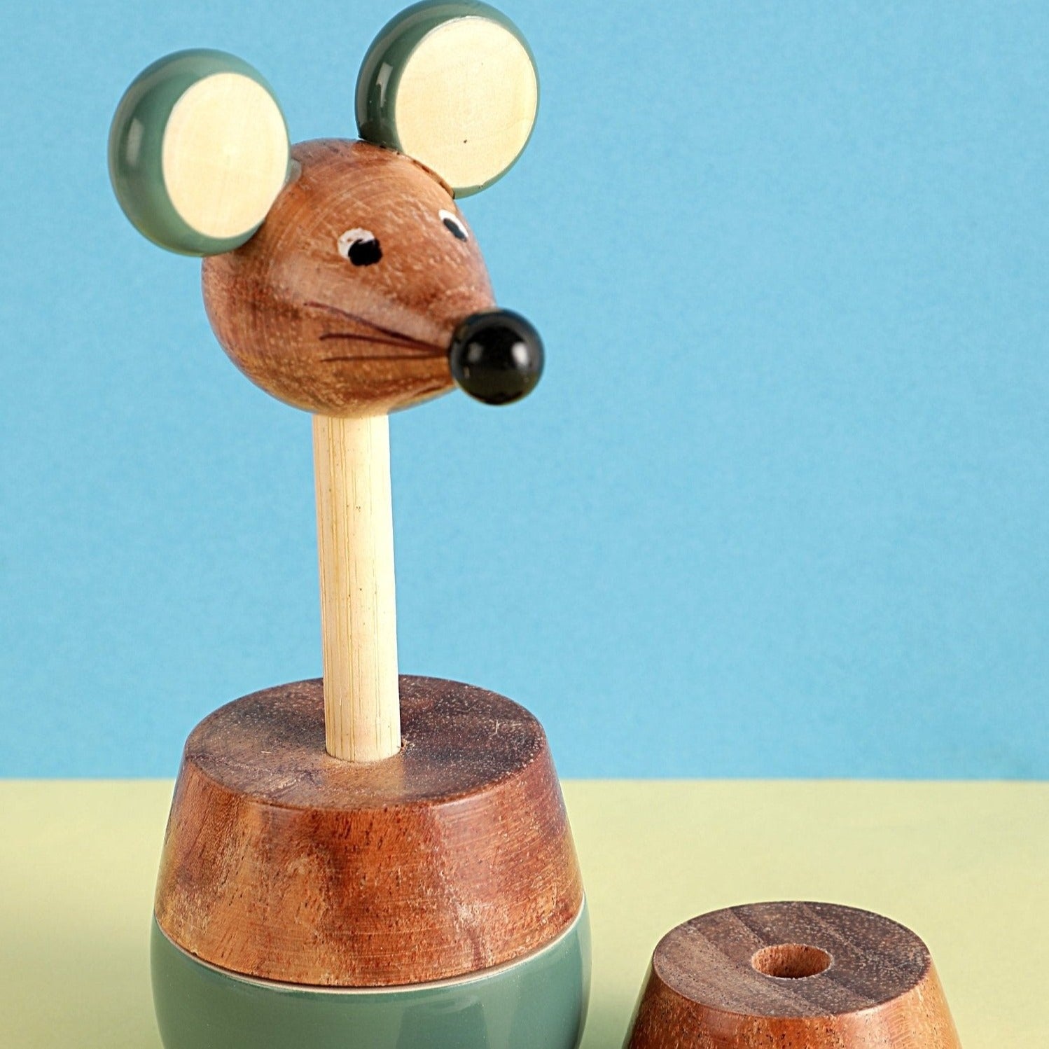 a wooden toy of a mouse on top of a table